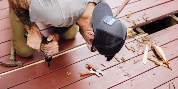Man repairing wooden decking